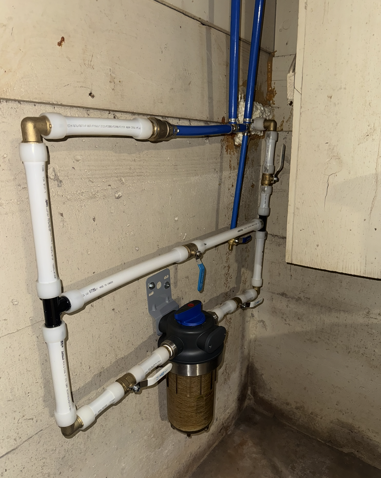 Main water shutoff — basement, quarter-turn valve at the whole house filter